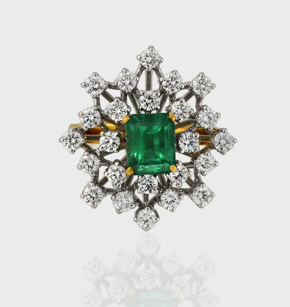 Ring, a captivating union of elegance and luxury, adorned with a stunning Emerald embraced by shimmering Diamonds.(PGDR0416)