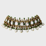 Exquisite flexible big Polki choker and earring set in fusion style, adorned with dazzling diamond rounds and emeralds. Elegantly strung with South Sea pearls and emerald beads - KMNE3565