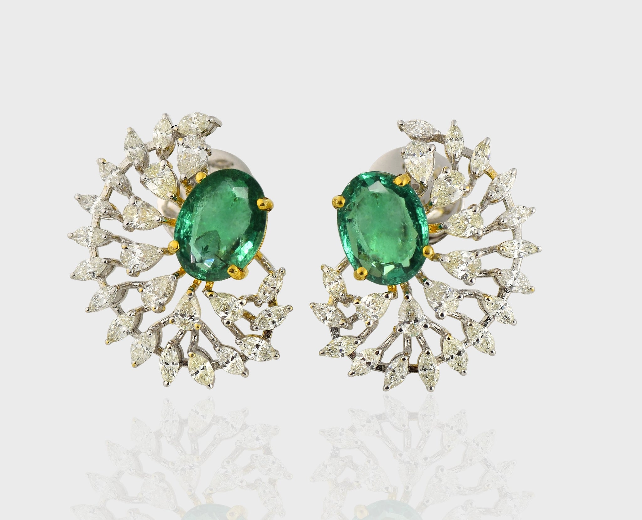 Step into elegance with our captivating half-round earring pair, showcasing exquisite emerald-cut ovals embraced by dazzling diamonds. Radiate sophistication with every turn.(PGDE0341)