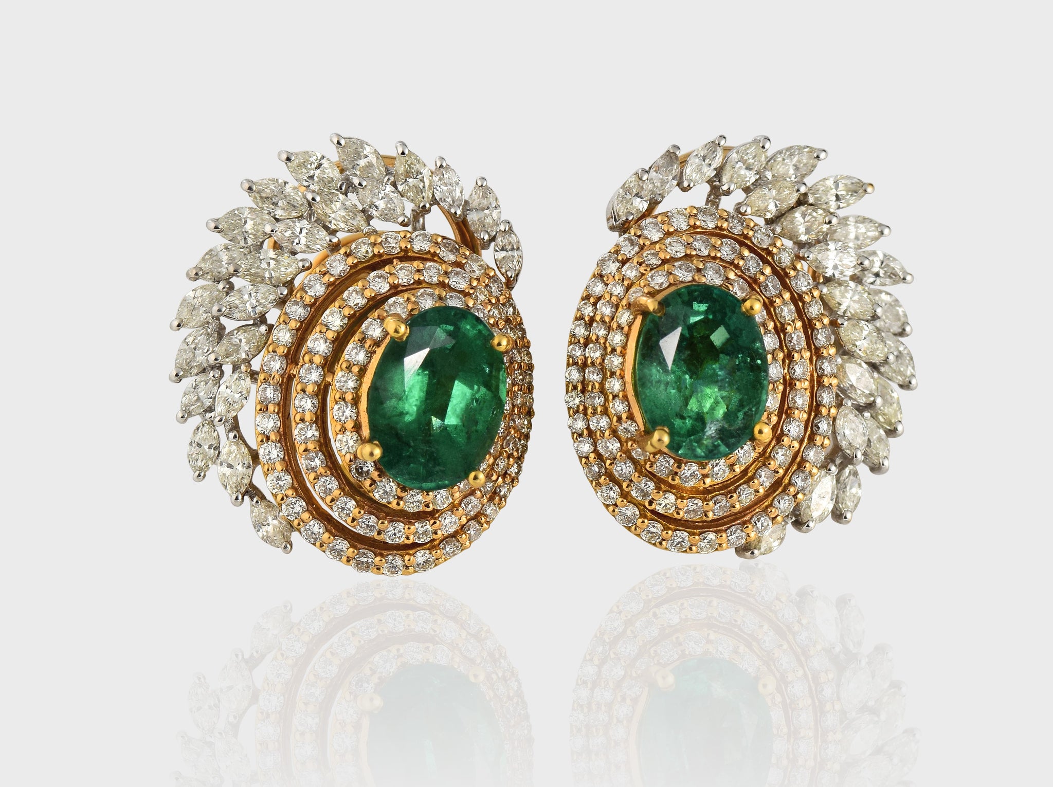 Earring pair with Radiant emeralds and diamonds intertwine in mesmerizing round and marquise cuts, set in a captivating dance of white and yellow gold.(PGDE0144)