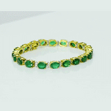 Radiate timeless elegance with this exquisite emerald and diamond bangle, where vibrant green gemstones and dazzling diamonds create a refined statement of luxury and grace.(GDBR0068)