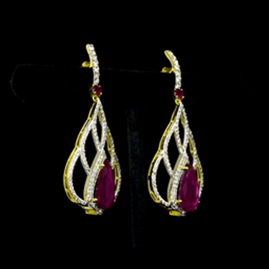 Brilliant diamonds embrace vibrant pear-shaped rubies in an elegant openwork silhouette, creating timeless earrings with graceful contemporary sophistication.(GDE0480)