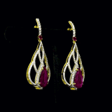Brilliant diamonds embrace vibrant pear-shaped rubies in an elegant openwork silhouette, creating timeless earrings with graceful contemporary sophistication.(GDE0480)
