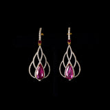 Brilliant diamonds embrace vibrant pear-shaped rubies in an elegant openwork silhouette, creating timeless earrings with graceful contemporary sophistication.(GDE0480)