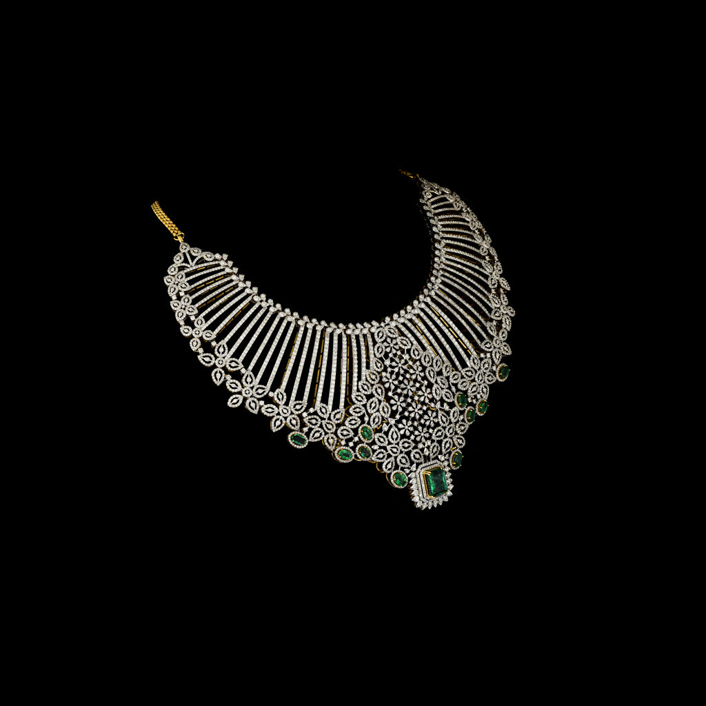 Exude timeless elegance with this stunning diamond and emerald necklace and earring set. A bold designer masterpiece, perfect for grand occasions.(GDNE0510)