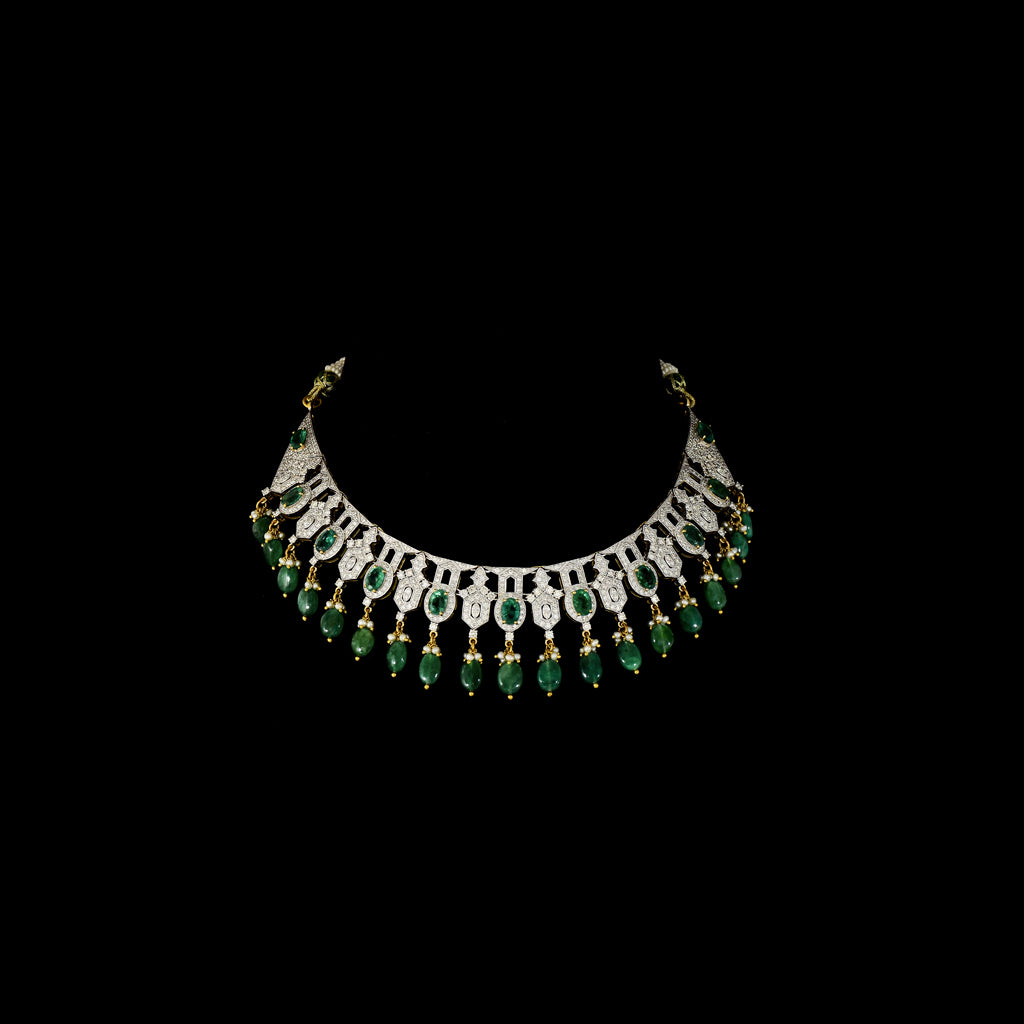 This elegant necklace set features sparkling diamonds and rich green emeralds, beautifully paired with emerald maniya stringing. A perfect blend of classic charm and modern design, ideal for weddings, parties, or special occasions. (GDNE0512)