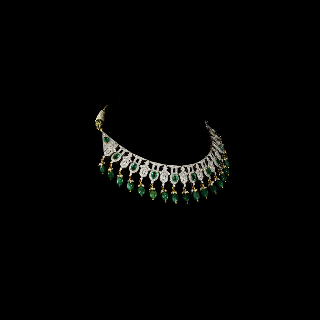 This elegant necklace set features sparkling diamonds and rich green emeralds, beautifully paired with emerald maniya stringing. A perfect blend of classic charm and modern design, ideal for weddings, parties, or special occasions. (GDNE0512)