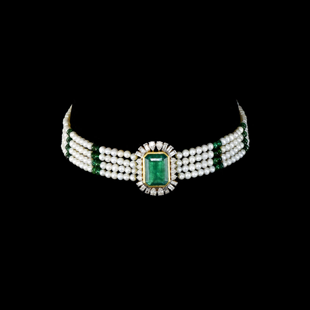 Exquisite choker necklace and tops pair for featuring a majestic central emerald, surrounded by dazzling diamonds. Adorned with rows of lustrous pearls and emerald beads, it blends traditional elegance with royal charm.(GDNE0526)