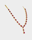 An elegant single-line necklace adorned with round diamonds and ruby cabochon drops, creating graceful movement, rich colour, and timeless sophistication. (GDNE0532)
