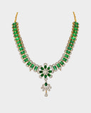 An exquisite necklace and earring set featuring oval emeralds with mutual-cut diamond centres, accented by round diamonds for timeless elegance, luxurious brilliance, and sophisticated charm. (GDNE0535)