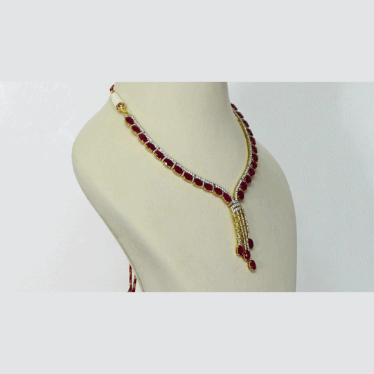 Ruby Cascade Diamond Necklace Set Brilliant oval rubies paired with sparkling diamonds create a graceful necklace set, complemented by elegant drop earrings for timeless sophistication and refined luxury.(GDNE0541)