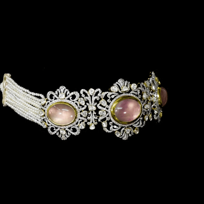 A beautifully structured choker featuring blush rose quartz centers, framed with polki and round diamonds, paired with matching statement earrings. (GDNE0542)