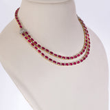 Ruby Radiance Double-Line Necklace Set A captivating double-line necklace showcasing vibrant oval rubies and sparkling diamonds, paired with elegant matching earrings for timeless glamour, sophistication, and luxurious brilliance.(GDNE0548)