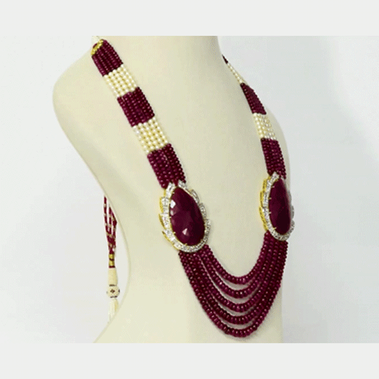 Regal Ruby Beaded Statement Necklace A magnificent statement necklace featuring oversized ruby centrepieces framed with dazzling diamonds, gracefully strung with ruby beads and luminous pearls for unmatched royal elegance.(GDNE0552)