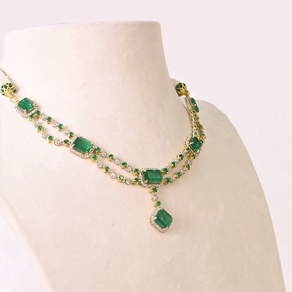 A stunning blend of emerald-cut emeralds and sparkling diamonds, this elegant necklace set is crafted to make every occasion unforgettable.(GDNE0553)