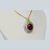 An exquisite pendant and earring set featuring red oval ruby cabochons accented with brilliant diamonds. Offering timeless elegance, rich colour, and refined luxury for a striking statement. (GDPE0403)