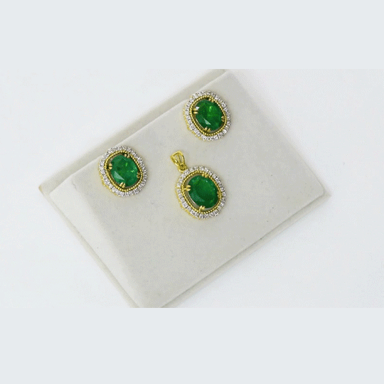 Classic pendant and earring set with oval emeralds and round diamonds, offering graceful elegance and timeless appeal. (GDPE0415 & GDE0475)