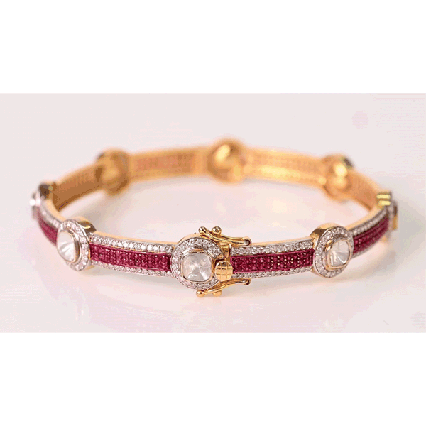 Delicate yet striking, this ruby and diamond bangle adds a touch of brilliance to every occasion.(KMB0628)