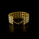 Versatile gold choker cum bracelet adorned with shimmering round diamonds, uncut diamond polki, and vibrant oval emerald accents, crafted in layered elegance to create a bold, luxurious statement for contemporary and traditional looks. (KMBR0150)