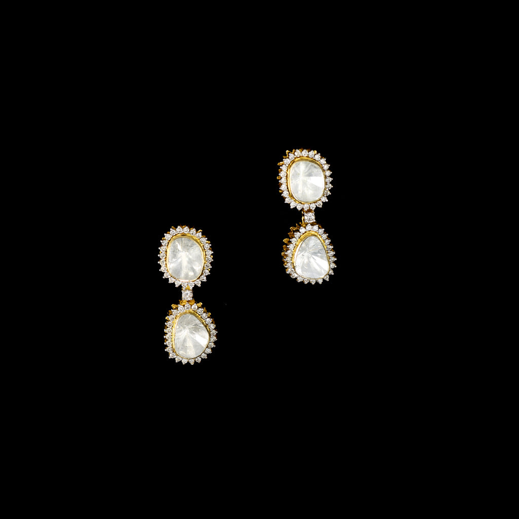 Elegant dangling earrings featuring a bold diamond Polki at the center, beautifully surrounded by sparkling round diamonds. A timeless design that adds graceful charm and brilliance to any special occasion.(KME2441)