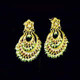 Stunning chandbali earrings adorned with sparkling Polki diamonds, rich red stones, and delicate pearl hangings, beautifully crafted to add royal elegance and festive charm to every celebration.(KME2524)