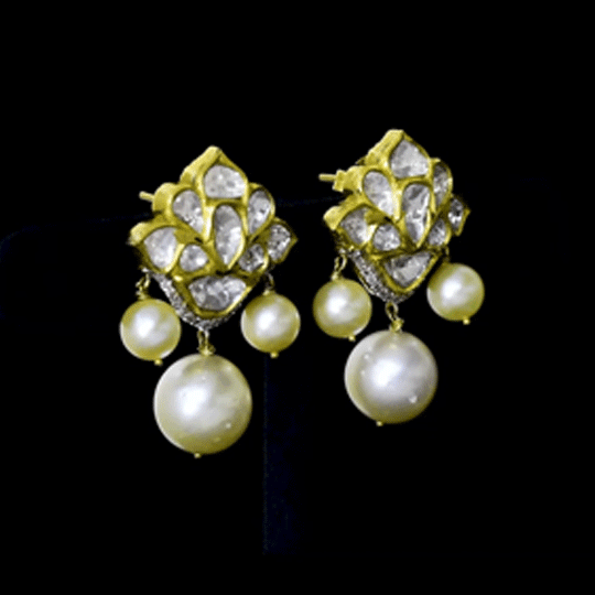 Gracefully crafted with radiant Diamond Polki, sparkling round diamonds, and South Sea pearl drops, these earrings exude refined luxury and effortless charm.(KME2531)