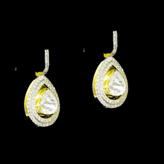 Diamond Polki Drop Earrings Designed to captivate, these drop earrings showcase luminous Diamond Polki framed by brilliant round diamonds, creating a graceful silhouette with modern sophistication and effortless sparkle.(KME2544)