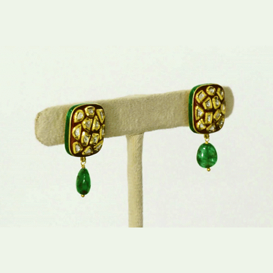 Timeless diamond polki tops adorned with rich red meenakari and elegant emerald maniya drops, celebrating heritage craftsmanship with refined sophistication.(KME2548)