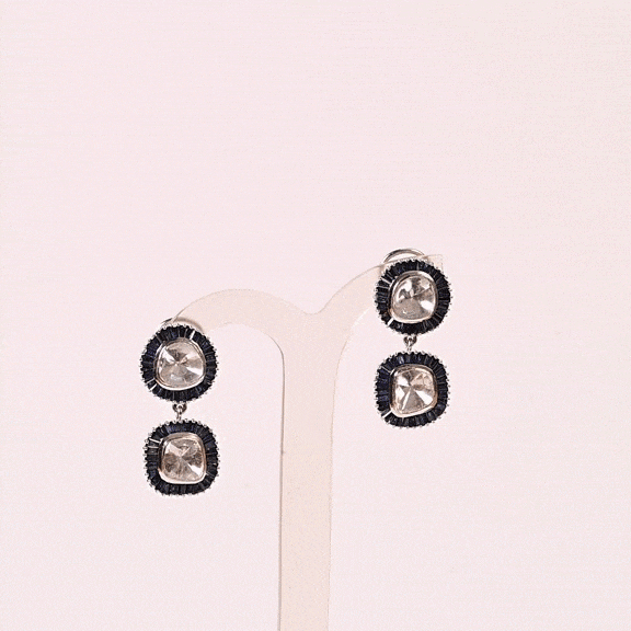 A striking harmony of natural Polki diamonds and calibre-cut blue sapphires, crafted into graceful statement earrings.(KME2562)