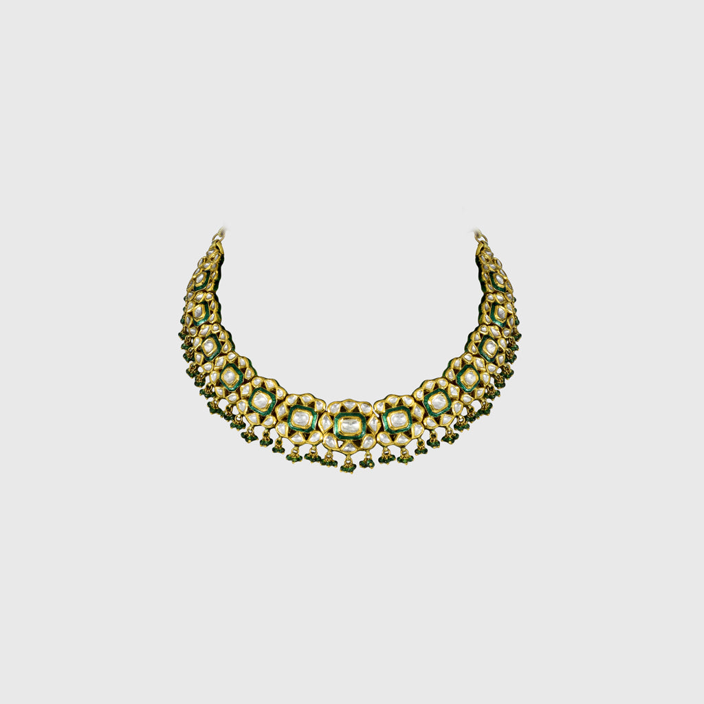 Elevate your elegance with this exquisite green Meena necklace and earring set, adorned with uncut diamonds. A timeless fusion of traditional artistry and luxury, perfect for weddings and grand celebrations.(KMNE3525)