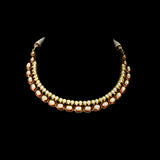 Radiate regal charm with this stunning red enameled necklace and earring set, intricately crafted with uncut diamonds. A perfect blend of heritage and glamour for festive occasions and bridal elegance. (KMNE3553)
