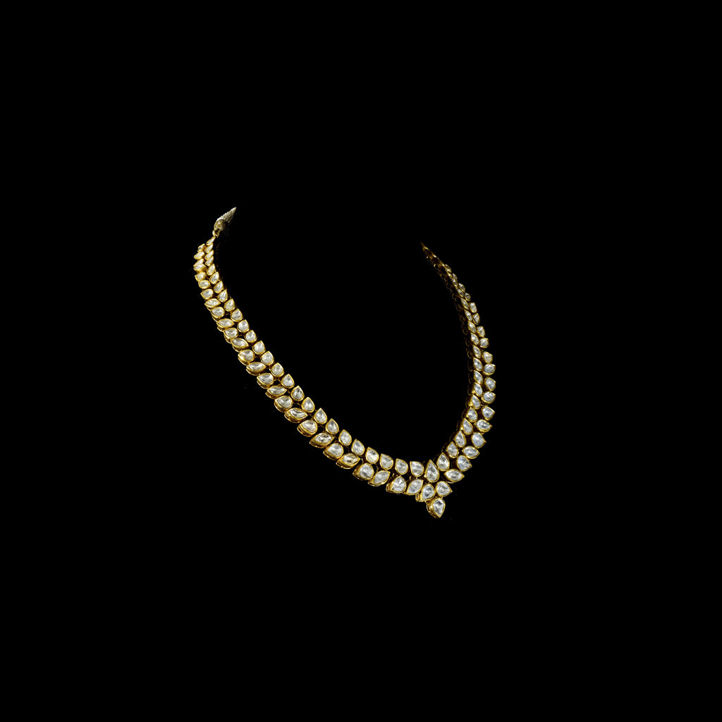 Elegant and timeless, this white two-line connected long necklace and earring pair features dazzling uncut diamonds. Perfect for adding grace and sparkle to weddings, festive events, or special celebrations.(KMNE3590) + (KME2373)