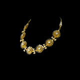 Delicate and dazzling, this necklace and earring pair features uncut diamond polki in an elegant open setting, crafted in a graceful floral design. A perfect blend of timeless beauty and fine craftsmanship for special occasions and celebrations.(KMNE3596)