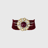 This exquisite piece features a central ruby cabochon surrounded by uncut and round diamonds in a floral design, beautifully strung with ruby beads on both sides. A perfect blend of grace and grandeur.(KMNE3603)