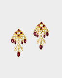 A striking necklace and earring set adorned with diamond polki and rich ruby stones, strung with ruby maniya and pearls. A timeless expression of heritage artistry and refined luxury, perfect for festive and celebratory moments. (KMNE3637)