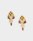 A striking necklace and earring set adorned with diamond polki and rich ruby stones, strung with ruby maniya and pearls. A timeless expression of heritage artistry and refined luxury, perfect for festive and celebratory moments. (KMNE3637)