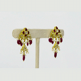 A striking necklace and earring set adorned with diamond polki and rich ruby stones, strung with ruby maniya and pearls. A timeless expression of heritage artistry and refined luxury, perfect for festive and celebratory moments. (KMNE3637)