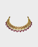 A striking necklace and earring set adorned with diamond polki and rich ruby stones, strung with ruby maniya and pearls. A timeless expression of heritage artistry and refined luxury, perfect for festive and celebratory moments. (KMNE3637)