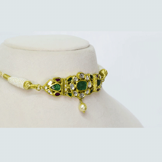 A mini necklace-cum-baju exquisitely crafted with diamond polki, carved emerald, and ruby accents, offering regal elegance with versatile traditional charm(KMNE3649)