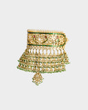 A traditional Rajasthani aad necklace and earring set crafted with diamond polki, accented by rich green stones and pearl stringing. An opulent expression of royal heritage and timeless bridal elegance. (KMNE3663)