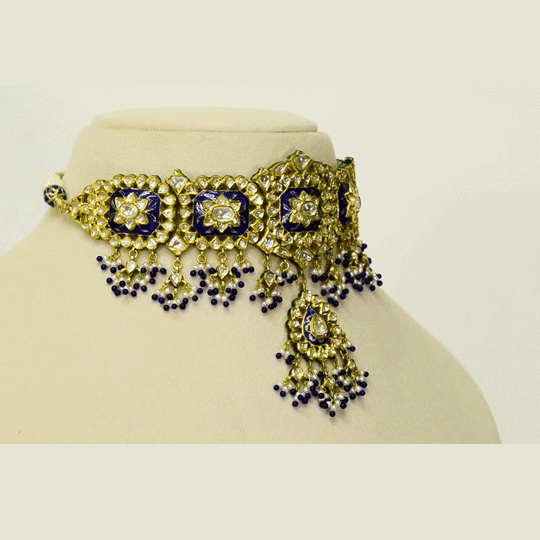A traditional blue meena choker necklace and earring set adorned with hand-set diamond polki and strung with luminous pearls. Blending heritage enamel artistry with timeless elegance, it’s perfect for weddings and festive occasions. (KMNE3677)