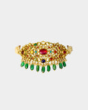 A regal Navratan stiff choker adorned with hand-set diamond polki and vibrant coloured stones, finished with emerald maniya and pearl stringing. A timeless statement of heritage craftsmanship and royal elegance. (KMNE3690)