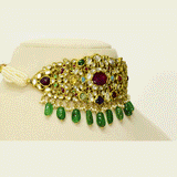 A regal Navratan stiff choker adorned with hand-set diamond polki and vibrant coloured stones, finished with emerald maniya and pearl stringing. A timeless statement of heritage craftsmanship and royal elegance. (KMNE3690)