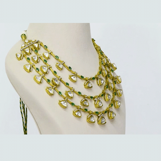 A fusion-style three-line necklace and earring set featuring diamond polki with round and emerald-cut oval diamonds, finished with sleek gold chain stringing. A contemporary take on timeless luxury, perfect for modern celebrations. (KMNE3701)