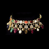 A breathtaking fusion-style Navratan necklace adorned with sparkling Polki diamonds, brilliant round diamonds, vibrant Navratan gemstones, and elegant pearls, crafted to celebrate timeless royalty, color, and unmatched festive glamour.(KMNE3716)