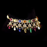 A breathtaking fusion-style Navratan necklace adorned with sparkling Polki diamonds, brilliant round diamonds, vibrant Navratan gemstones, and elegant pearls, crafted to celebrate timeless royalty, color, and unmatched festive glamour.(KMNE3716)