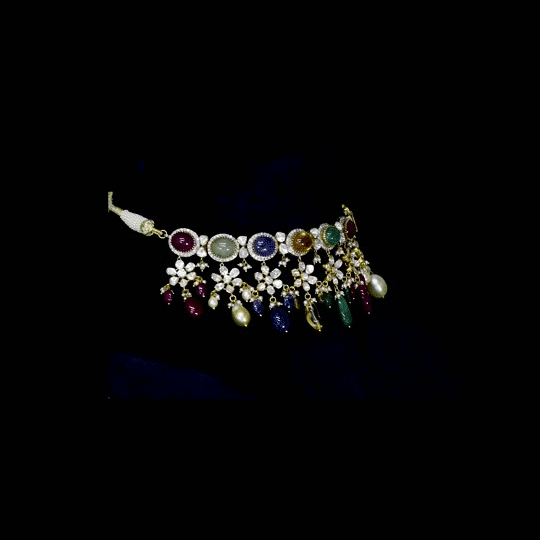A breathtaking fusion-style Navratan necklace adorned with sparkling Polki diamonds, brilliant round diamonds, vibrant Navratan gemstones, and elegant pearls, crafted to celebrate timeless royalty, color, and unmatched festive glamour.(KMNE3716)