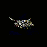 A breathtaking fusion-style Navratan necklace adorned with sparkling Polki diamonds, brilliant round diamonds, vibrant Navratan gemstones, and elegant pearls, crafted to celebrate timeless royalty, color, and unmatched festive glamour.(KMNE3716)