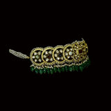 A fusion Navratan choker featuring polki diamonds in gold, highlighted with a central ruby, multicolored gemstones, intricate pearl detailing, and cascading emerald drops—paired with statement earrings for a rich, regal presence. (KMNE3719)