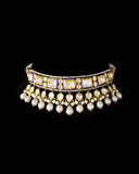 A regal blue enamelled choker set in gold, showcasing bold oversized polki diamonds framed with intricate detailing, finished with cascading South Sea pearl fringes and perfectly matched statement earrings for timeless grandeur. (KMNE3720)